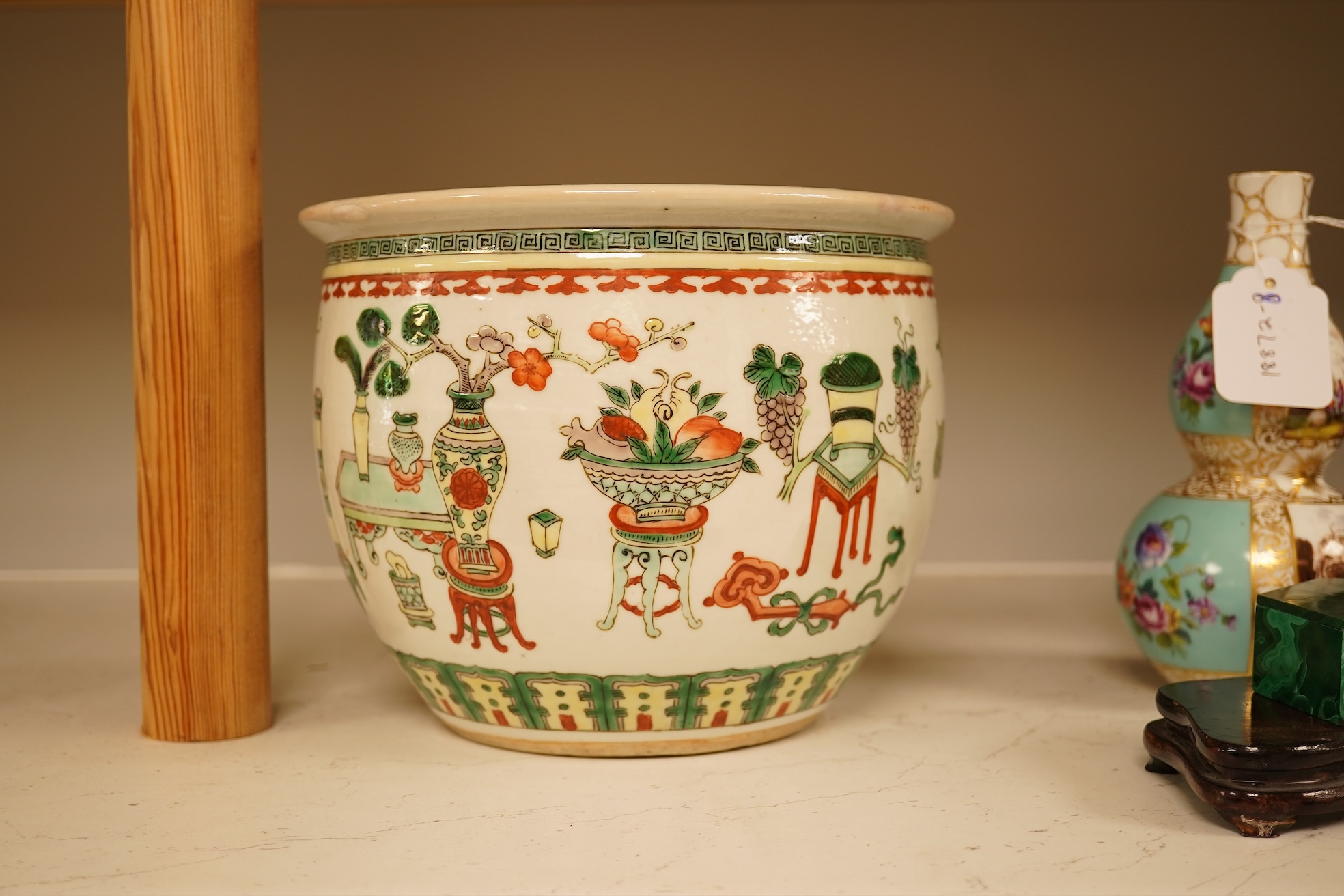A Chinese Hundred Antiques famille verte small jardiniere, 19th century, 17cm high, 21cm diameter.
